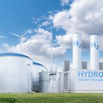 Modern hydrogen storage tanks and wind turbines, suggesting renewable energy integration and supporting the narrative of enhanced RFNBO Precertification standards for project maturity and compliance.